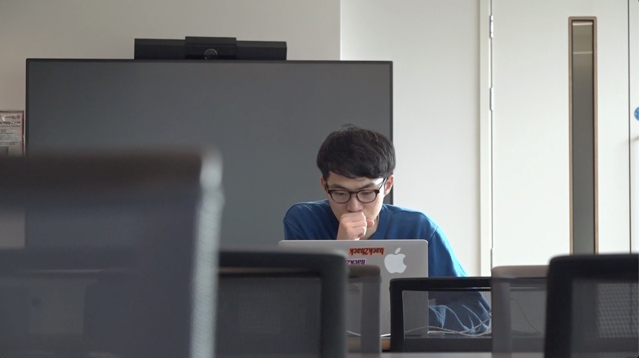 A student working at a laptop